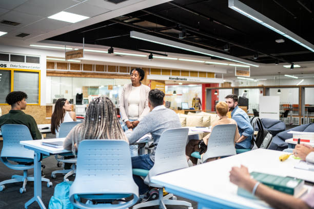 Female mature teacher talking students during class at university
